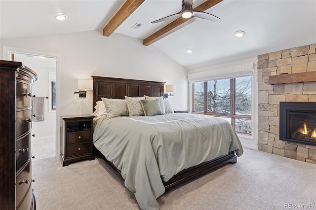 bedroom with vaulted ceiling with beams, a fireplace, light colored carpet, and ceiling fan