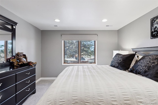 carpeted bedroom with multiple windows