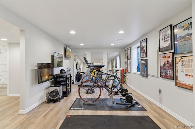 workout room featuring light hardwood / wood-style flooring