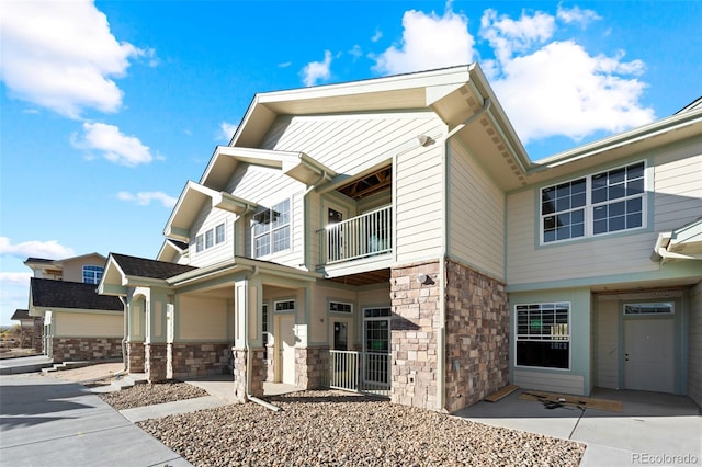 view of front of property featuring a garage and a balcony