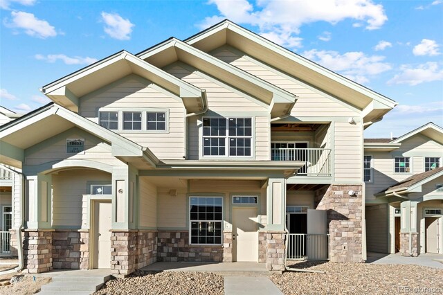 view of front of home with a balcony and a garage