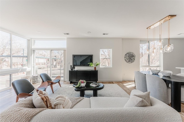 living area with light wood finished floors and visible vents