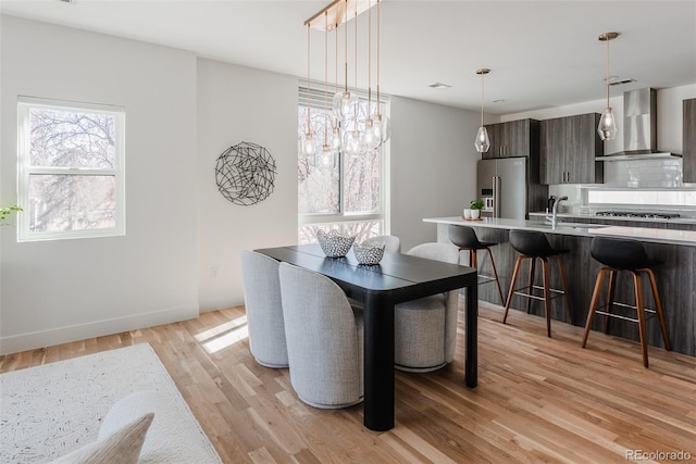 dining room with light wood-style flooring and baseboards