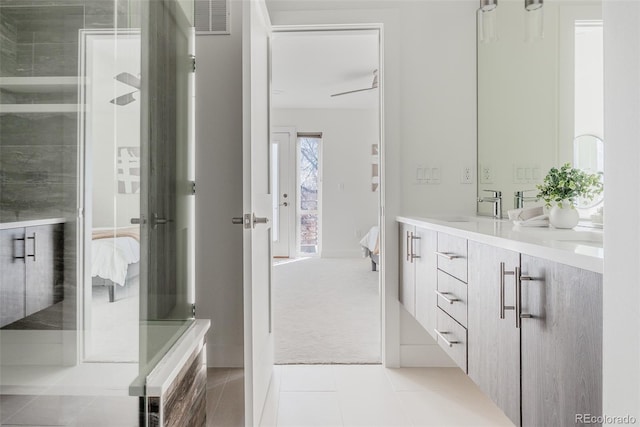 ensuite bathroom with double vanity, visible vents, ensuite bathroom, a sink, and tile patterned floors