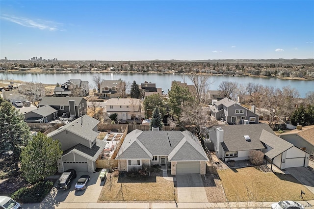 birds eye view of property featuring a water view and a residential view