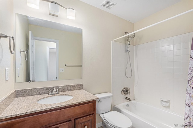 bathroom with visible vents, toilet, vanity, and shower / tub combo with curtain