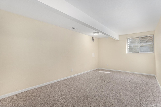 carpeted empty room with beam ceiling, visible vents, and baseboards