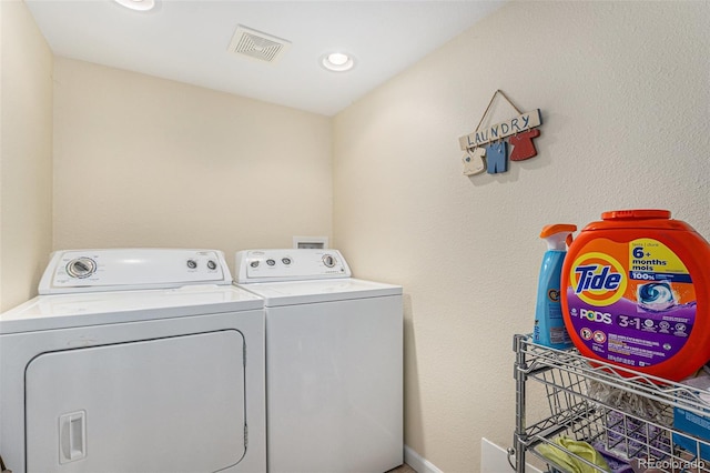 laundry room with laundry area, recessed lighting, visible vents, and washer and clothes dryer