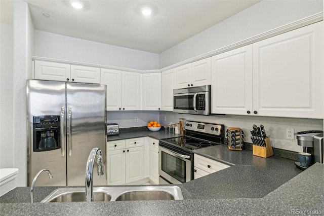 kitchen featuring stainless steel appliances, sink, and white cabinets