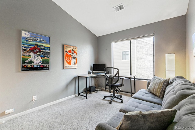 home office featuring vaulted ceiling and light colored carpet