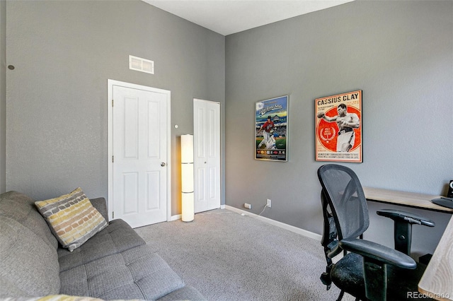 carpeted office with a high ceiling