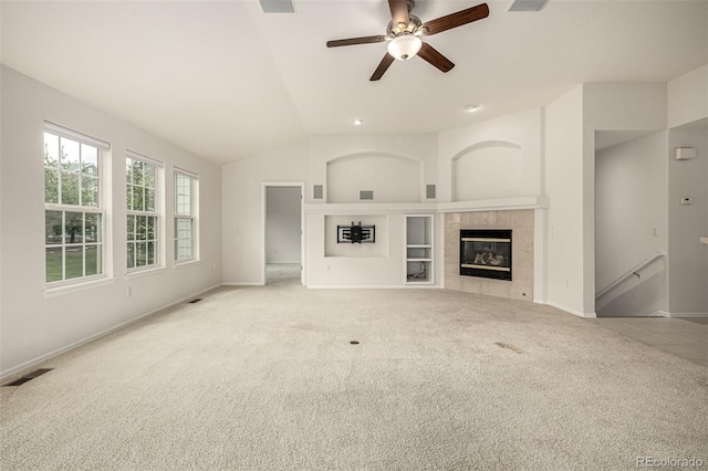8267 S Sicily Ct, Aurora, CO 80016 - unfurnished living room with carpet flooring, a fireplace, a ceiling fan, lofted ceiling, and baseboards