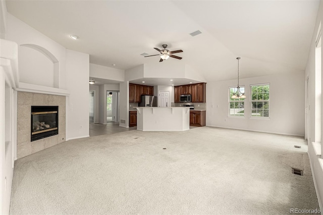 8267 S Sicily Ct, Aurora, CO 80016 - unfurnished living room with light colored carpet, a fireplace, ceiling fan, high vaulted ceiling, and baseboards