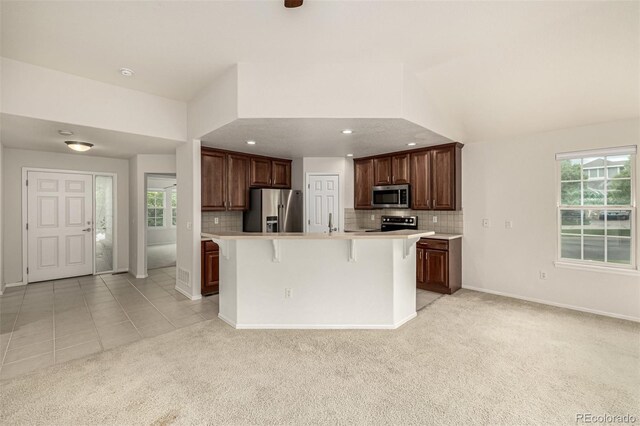 8267 S Sicily Ct, Aurora, CO 80016 - kitchen featuring stainless steel appliances, light colored carpet, light countertops, tasteful backsplash, and recessed lighting