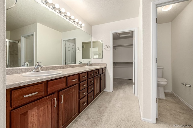8267 S Sicily Ct, Aurora, CO 80016 - full bath with double vanity, a stall shower, toilet, a textured ceiling, and baseboards