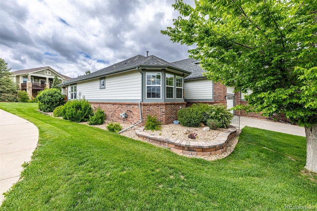 8267 S Sicily Ct, Aurora, CO 80016 - view of home's exterior with brick siding, a lawn, and a shingled roof