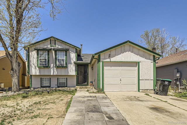 18891 E Carmel Dr, Aurora, CO 80011 - split level home with board and batten siding, concrete driveway, and an attached garage