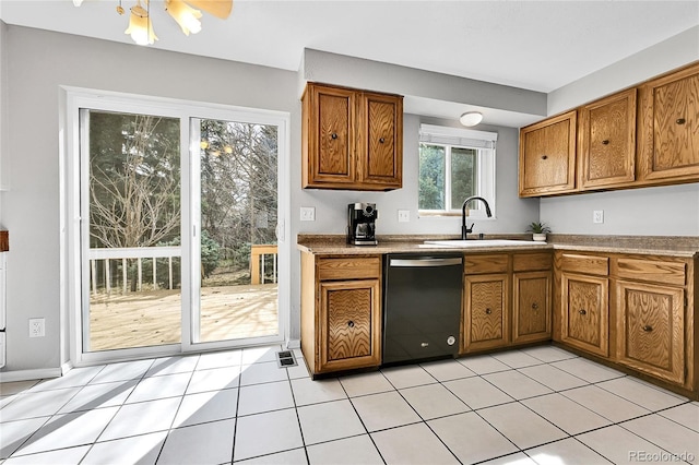 kitchen featuring a sink, brown cabinets, black dishwasher, and light tile patterned floors