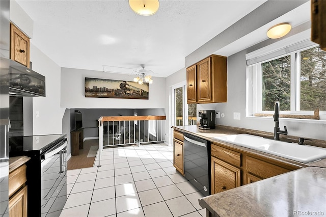 kitchen with black appliances, a sink, brown cabinetry, light countertops, and light tile patterned floors