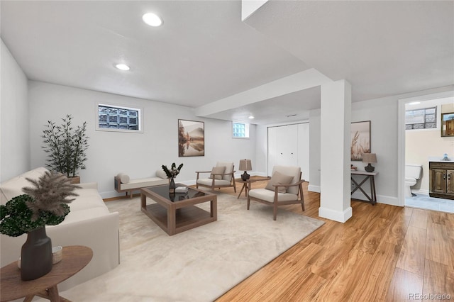 living area featuring recessed lighting, baseboards, and light wood finished floors