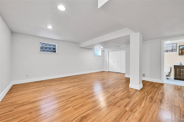 basement with recessed lighting, light wood-style flooring, and baseboards