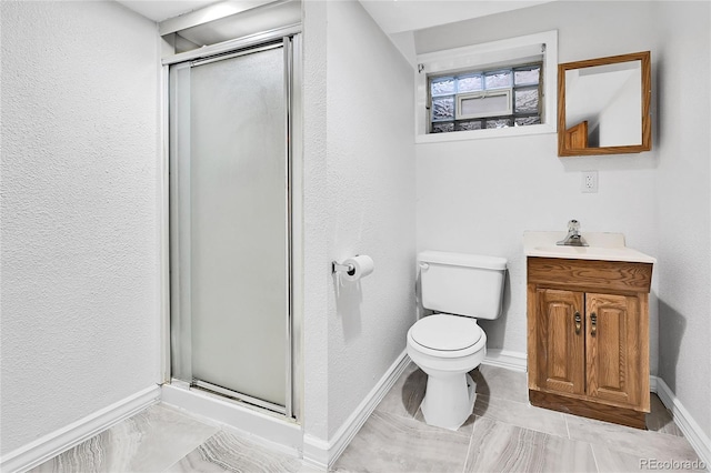 full bath featuring a stall shower, toilet, vanity, and baseboards