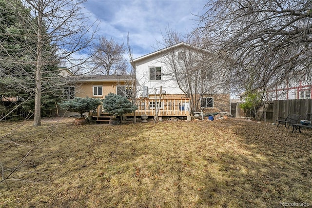 back of house with a wooden deck and fence