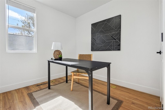 office featuring baseboards and light wood-style floors