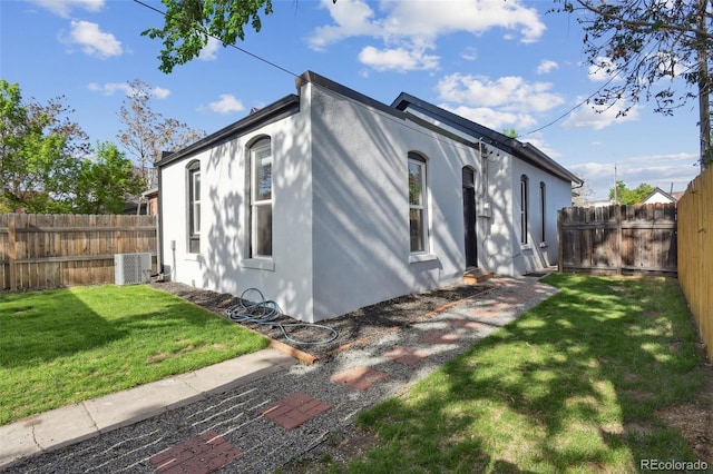 view of side of home featuring central air condition unit and stucco siding