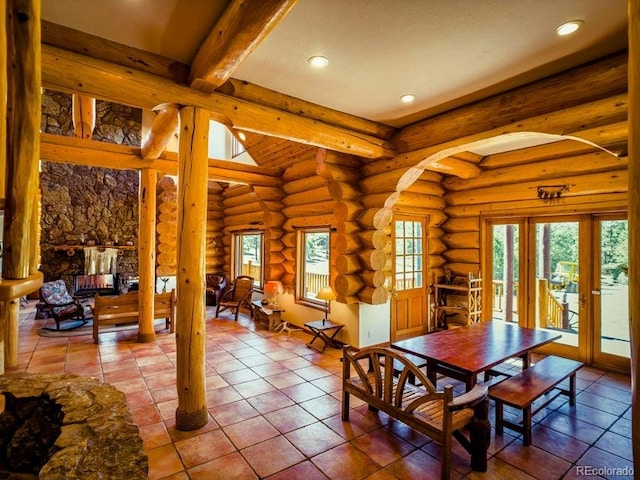 dining area featuring tile flooring, ornate columns, rustic walls, and beam ceiling