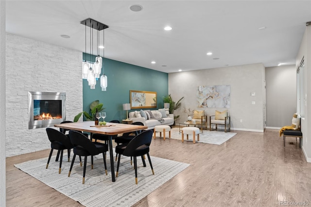 3384 Cranston Cir, Highlands Ranch, CO 80126 - dining room with a fireplace, wood finished floors, recessed lighting, and baseboards