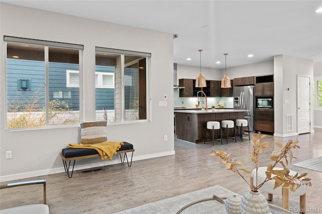 3384 Cranston Cir, Highlands Ranch, CO 80126 - living area featuring baseboards, light wood-type flooring, and recessed lighting