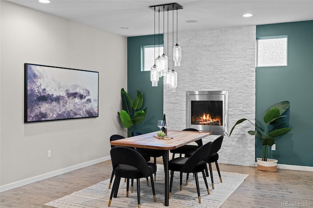 3384 Cranston Cir, Highlands Ranch, CO 80126 - dining area with plenty of natural light, a fireplace, wood finished floors, baseboards, and recessed lighting