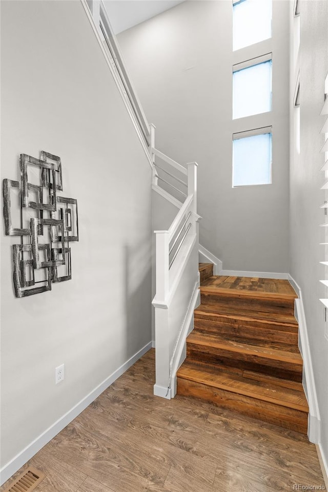 3384 Cranston Cir, Highlands Ranch, CO 80126 - stairs featuring wood finished floors and baseboards