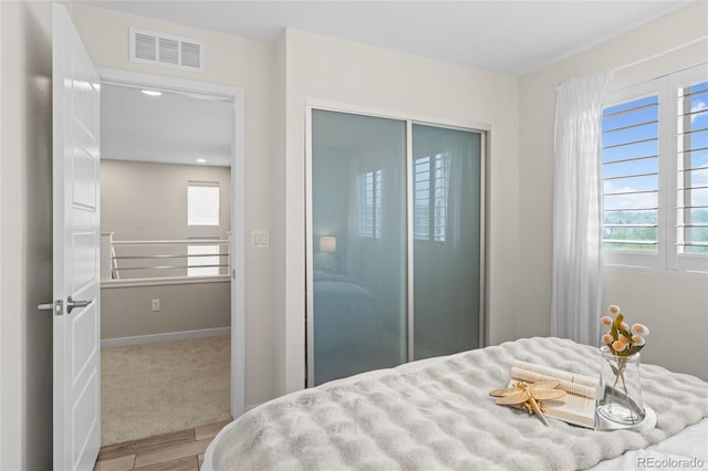3384 Cranston Cir, Highlands Ranch, CO 80126 - bedroom featuring wood finished floors, multiple windows, baseboards, and a closet