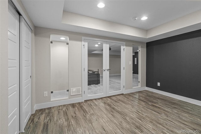 3384 Cranston Cir, Highlands Ranch, CO 80126 - empty room featuring wood finished floors, baseboards, recessed lighting, a smoke detector, and french doors