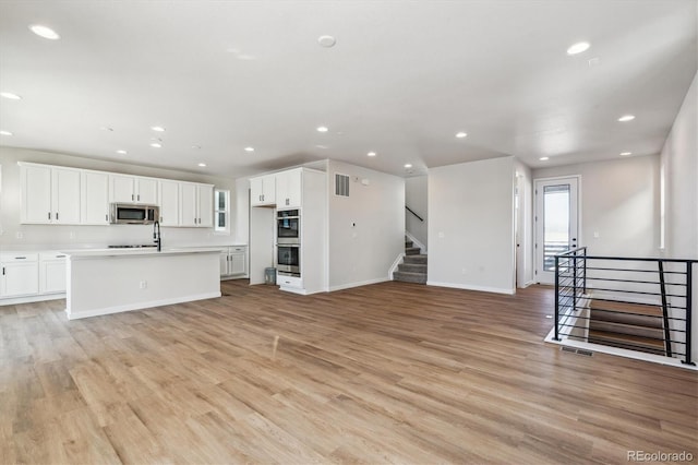 unfurnished living room featuring light hardwood / wood-style floors