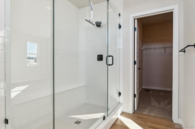 bathroom with wood-type flooring and walk in shower