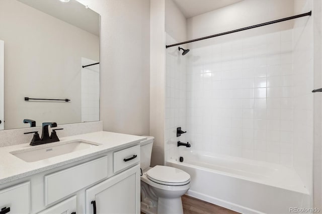 full bathroom featuring vanity,  shower combination, hardwood / wood-style flooring, and toilet