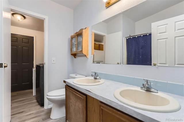 bathroom with hardwood / wood-style flooring, vanity, and toilet