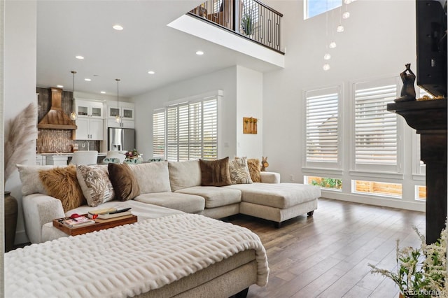 living area with hardwood / wood-style floors and recessed lighting