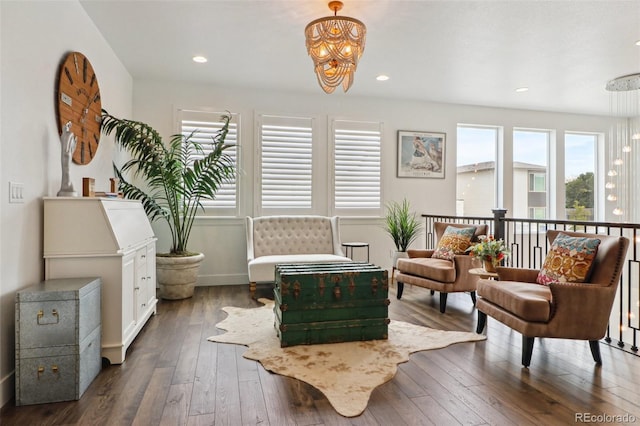 sitting room featuring a chandelier, recessed lighting, plenty of natural light, and dark wood-type flooring