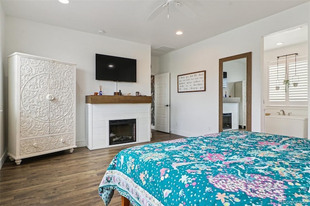 bedroom with ceiling fan, a fireplace, recessed lighting, and wood finished floors