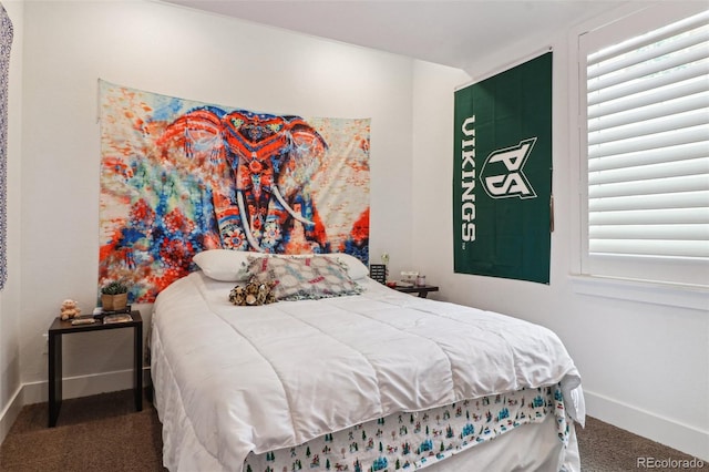 bedroom with carpet floors and baseboards
