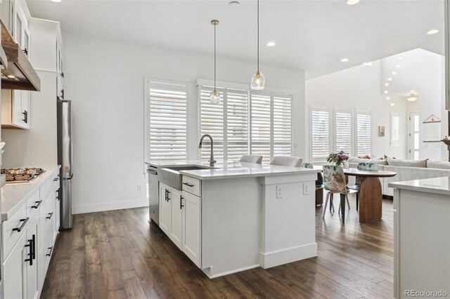 kitchen with a sink, white cabinets, and dark wood finished floors