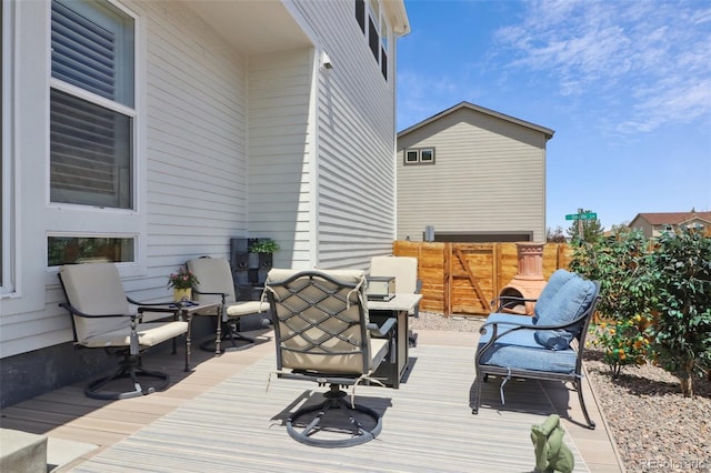 wooden terrace featuring fence