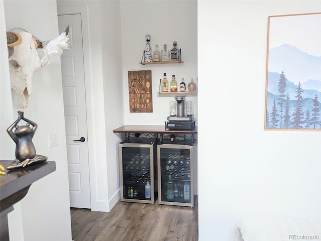 indoor dry bar featuring wood finished floors, wine cooler, and baseboards