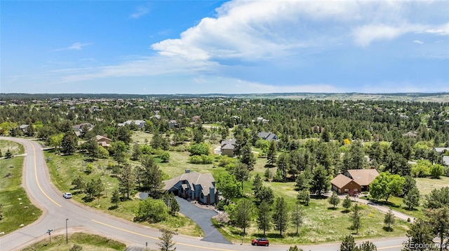 birds eye view of property featuring a view of trees