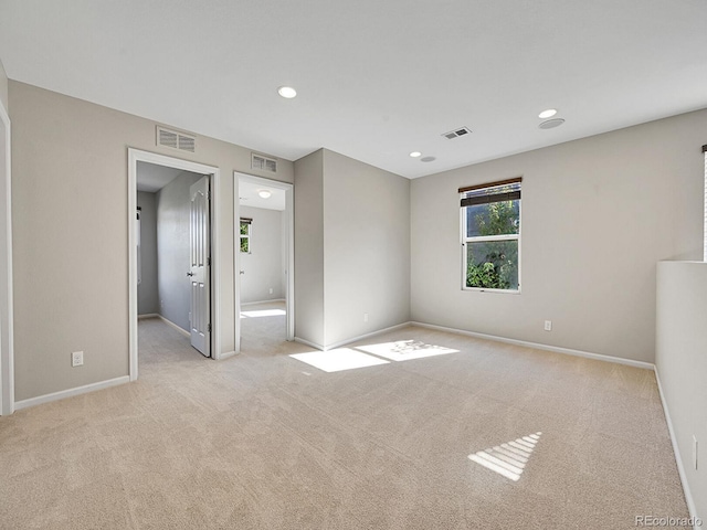 unfurnished bedroom with light colored carpet