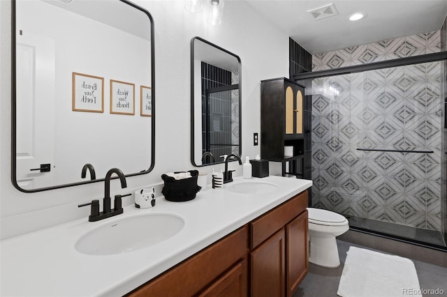 bathroom with an enclosed shower, vanity, and toilet